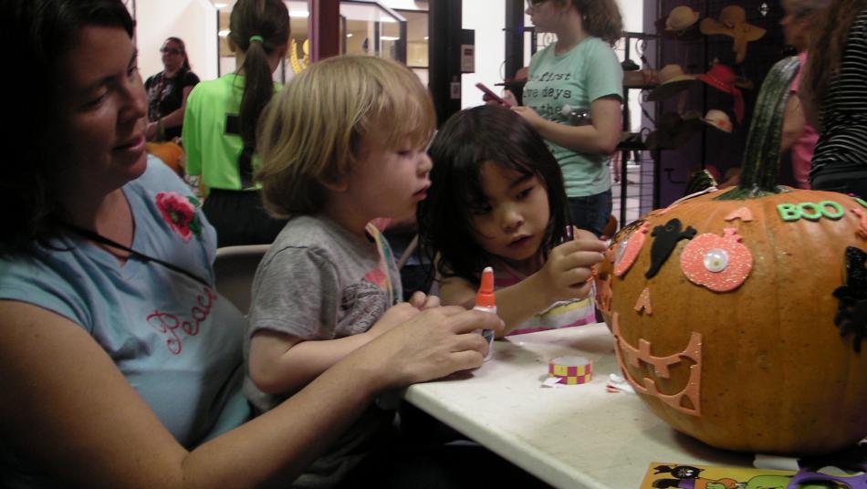 Alisa Kuniya brought her two children Toshi, 3 and Miya, 6, to the Scarecrow Festival for pumpkin decorating.