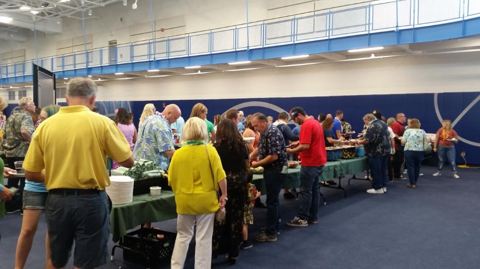 Attendees line up for ribs, roast pork, and more.
