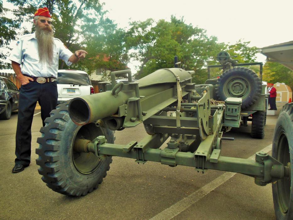 A piece of field hardware towed behind a vintage USMC Jeep.