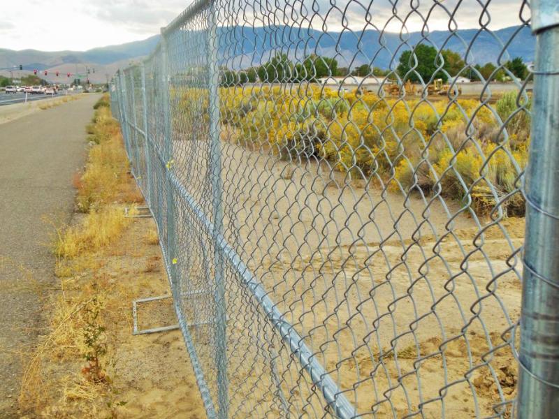 Photos by Brett Fisher. New chain link fencing erected along Hwy 50 East.
