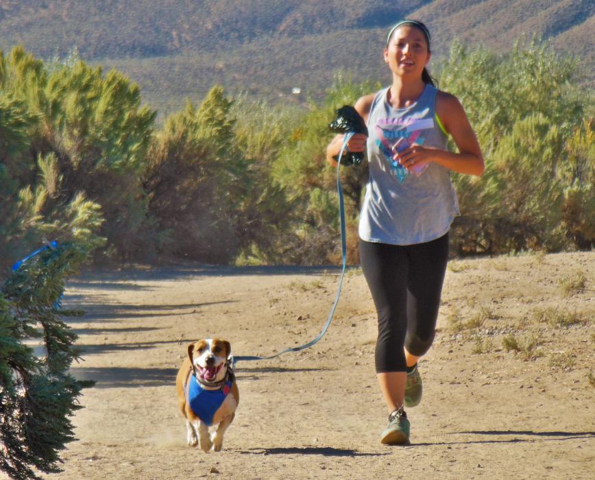 A woman and her dog finish the 5K Run at Riverview Park.