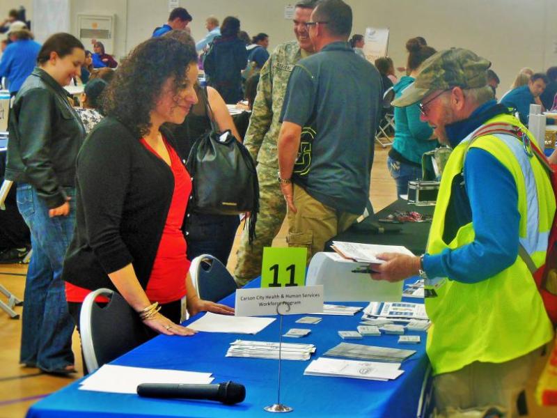 Photos by Brett Fisher. Ana Gregg (left) talks with a job seeker at the February 2016 Job Fair.