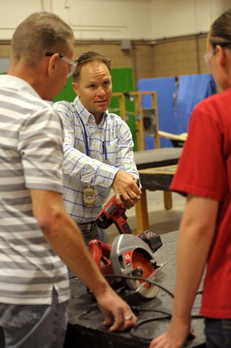 Rick Robinson, left, and Susanne Whimple, right, receive hands-on instruction from Nigel Harrison.