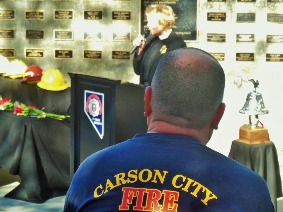 A Carson City firefighter listens to the CCFD chaplain address the memorial service Saturday.