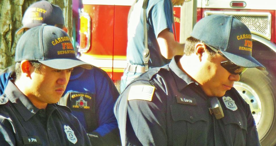 Carson City Firefighters lower their heads in remembrance of four fallen brethren.
