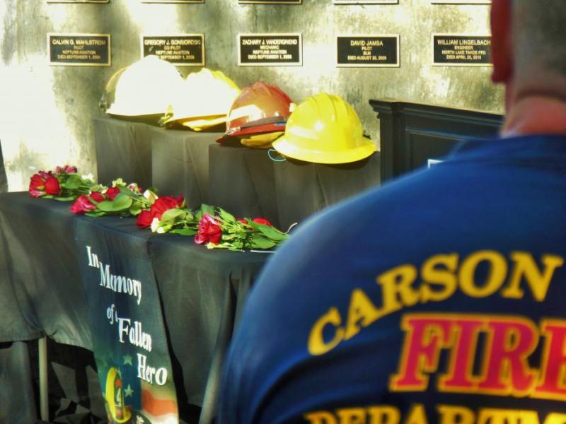 Photos by Brett Fisher. A member of the Carson City Fire Dept. looks on as four fallen firefighters are remembered Saturday.