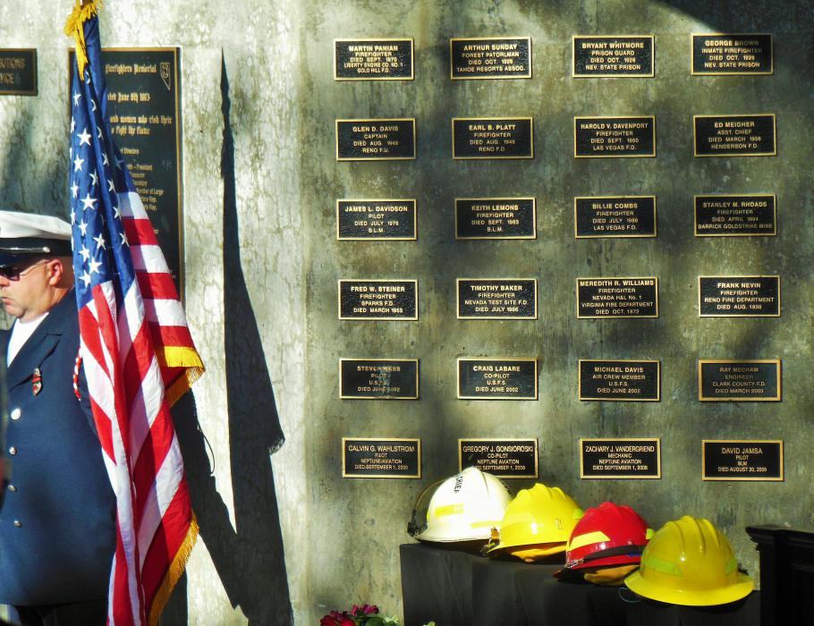 Fallen firefighter helmets amidst the plaques for other fallen firefighters.
