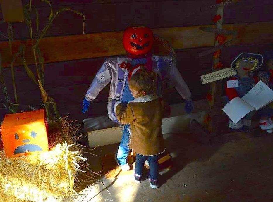 Jade Belville, 2, of Reno hugs a scarecrow inside Wabuska Station.