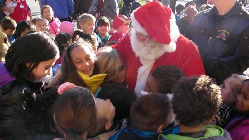 Children gather to meet Santa Claus at the 2015 Holiday with a Hero event at Walmart in Carson City.