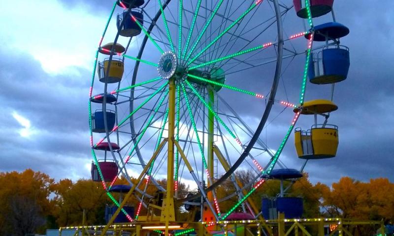 Photos by Brett Fisher. The bright lights of a carnival and the fiery colors of fall in Mills Park.