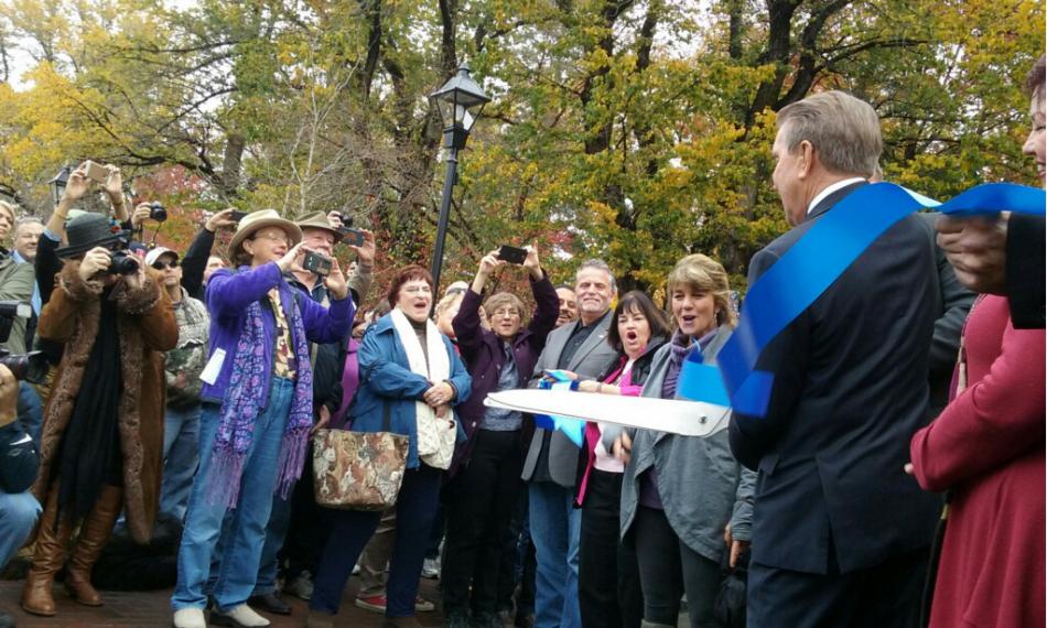 Carson City Mayor Bob Crowell helps cut the ribbon on Carson Street on Friday. Photo by Brett Fisher