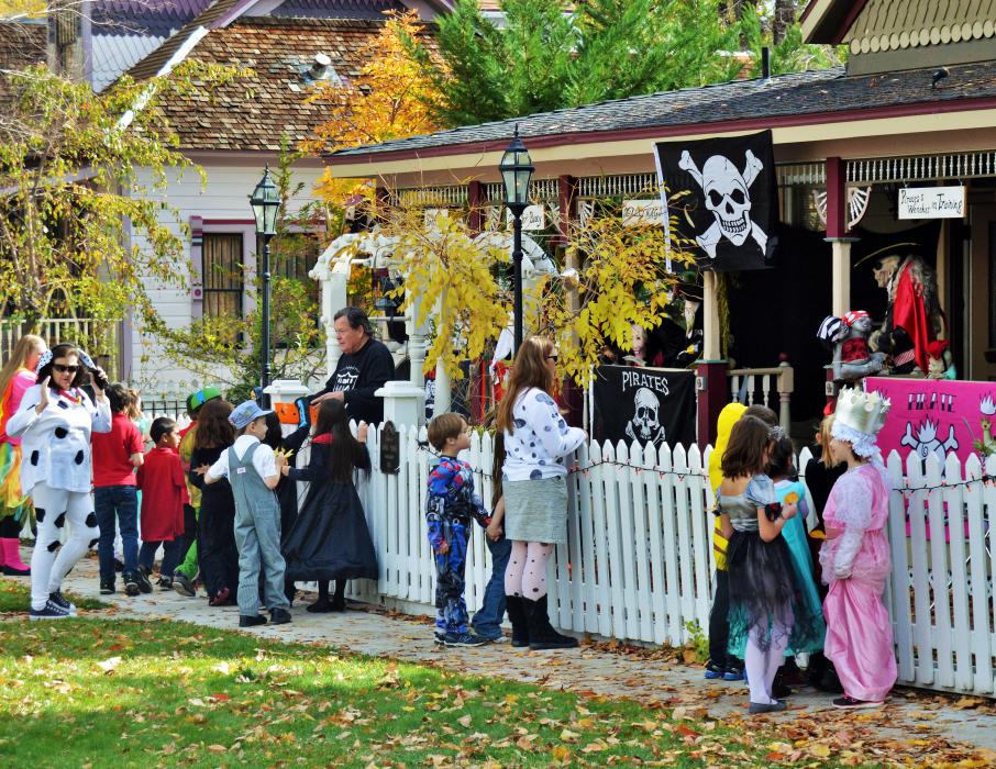 Photo by Brett Fisher. Schoolchildren trick or treat at a residence on West Robinson Street Monday.