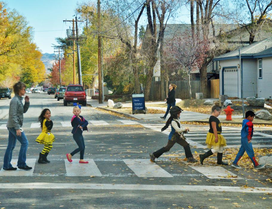 Photo by Brett Fisher. Children cross Telegraph Street at a crosswalk Monday.