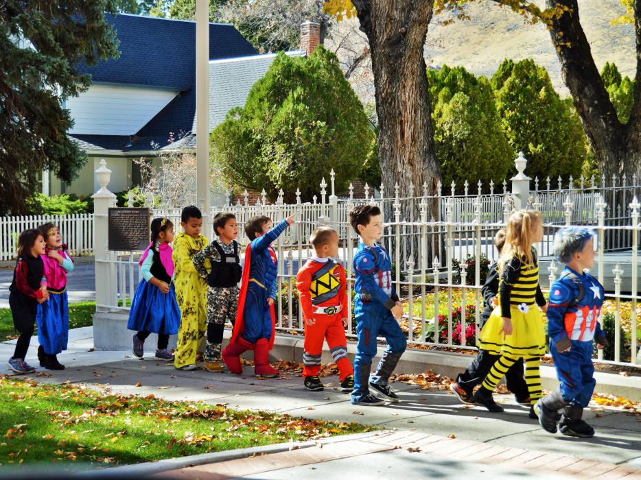 Photo by Lisa Fisher. Children in their costumes on the sidewalk at the Governor's Mansion Monday.
