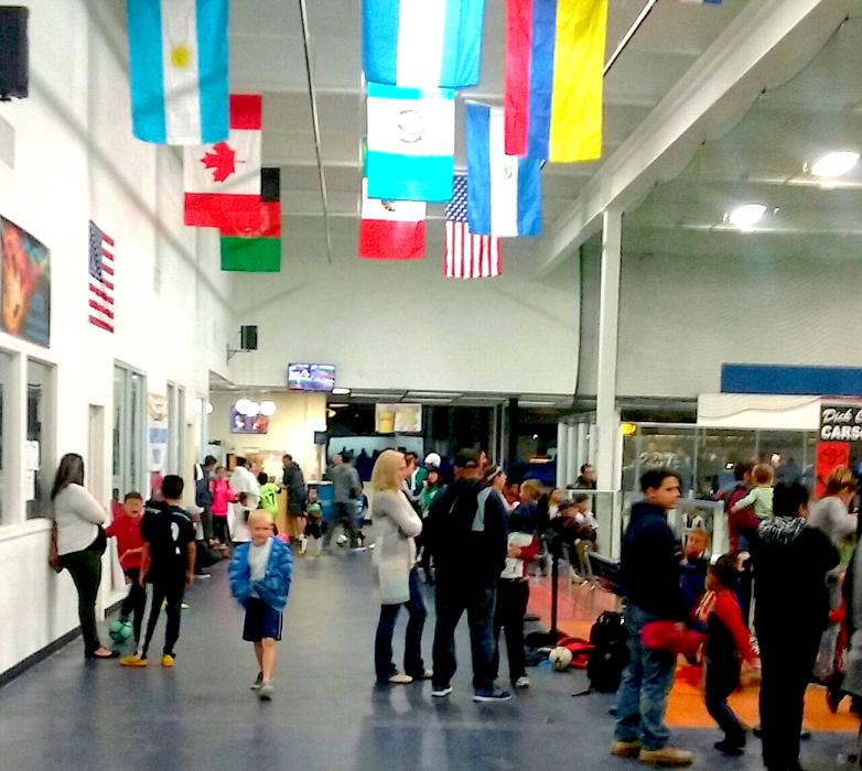 Families gather to watch an indoor youth soccer match at TAC.