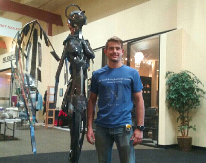 Photo by Brett Fisher. Logan Peterson with his sculpture, 