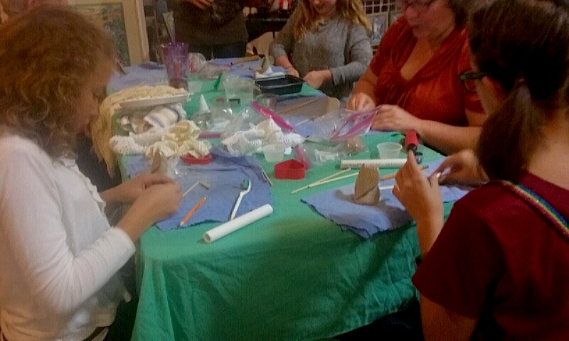 Adults and children participate in a sculpture activity put on by Ogres-Holm Pottery.