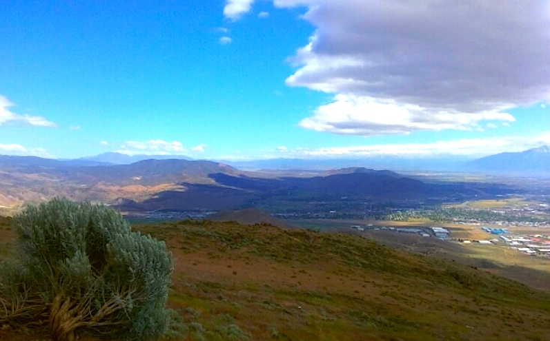 Photo by Brett Fisher. Partly cloudy skies over Carson City from atop McMillian Peak.