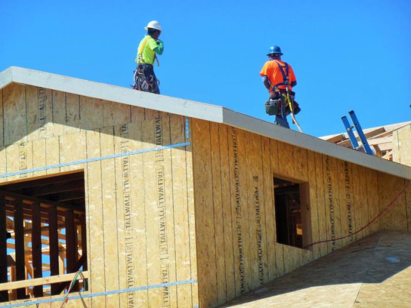 Photo by Brett Fisher. Construction workers on the roof of Richard's Crossing along Jeanell Drive.