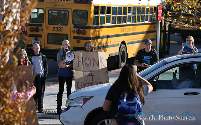 Brian Williams, right center, and students compliment drivers at the school. Cathleen Allison, Nevada Photo Source