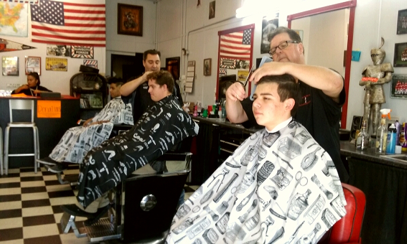 Photo by Brett Fisher. Jeff Nichols and his staff cut hair Friday for Honor Flight Nevada.