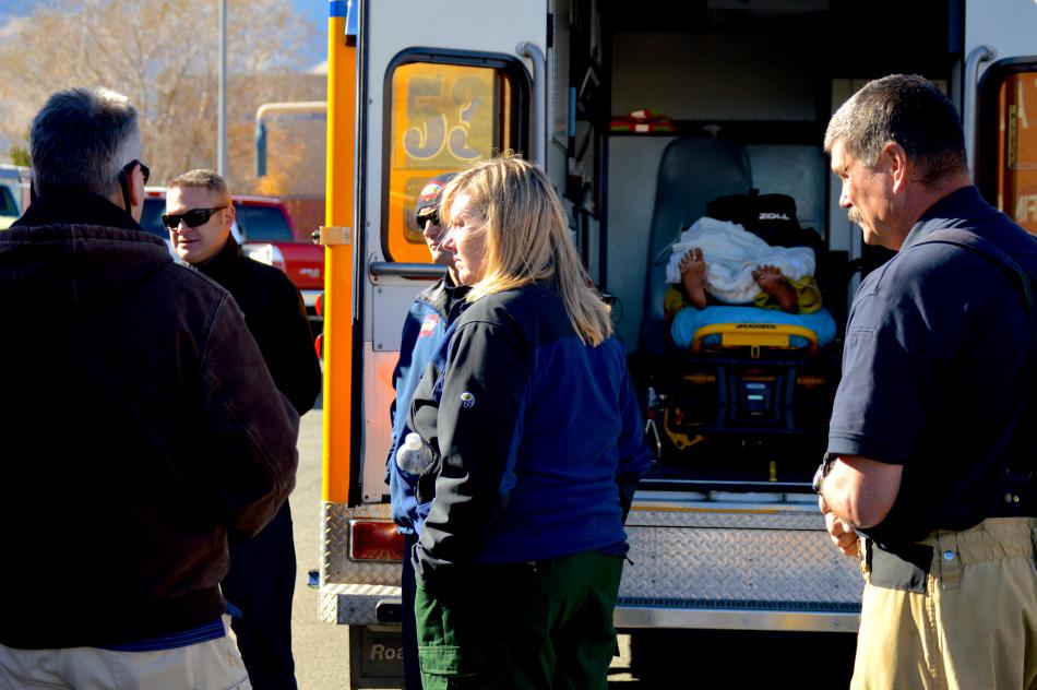 Paramedics and trainees discuss the cardiac arrest exercise.