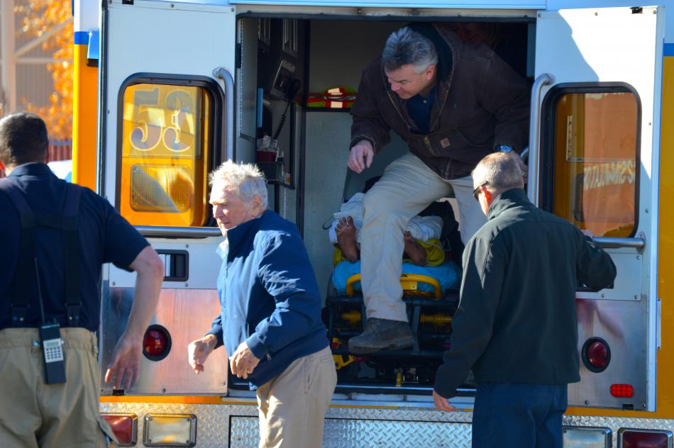 Trainees disembark the rear of an ambulance after a simulated cardiac arrest transport.
