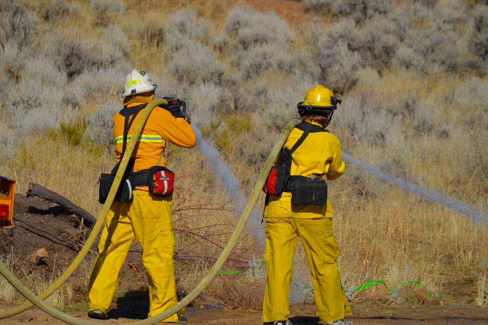 Firefighters creating a water line during a wildland fire exercise along Goni Canyon Rd.