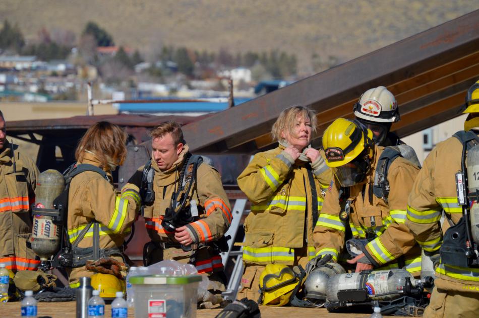 Trainees suit up for a structure fire exercise.