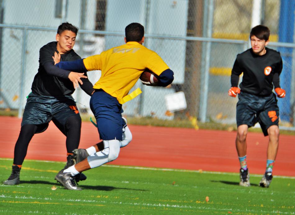 Navy quarterback gives a Douglas defender a stiff arm.
