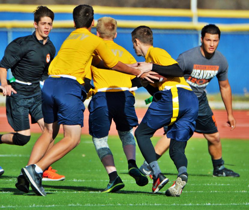 Navy quarterback hands off to the ball carrier during a play in the red zone.