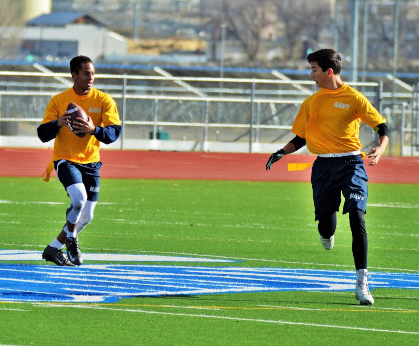 Navy quarterback and receiver communicate during a live play.