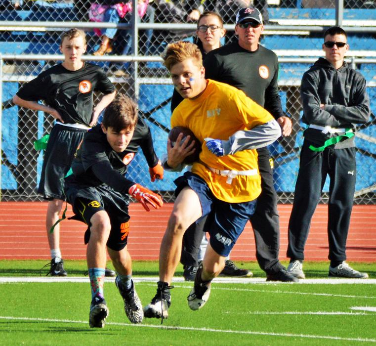 Photos by Brett Fisher. A Carson High Navy ball carrier tries to avoid a Douglas tag Saturday.
