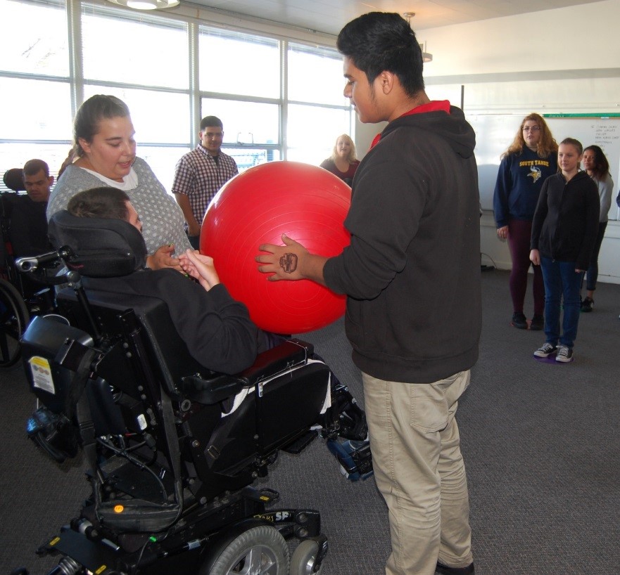 10th grade Pioneer student Isaiah Zacarias helps an EVCH student