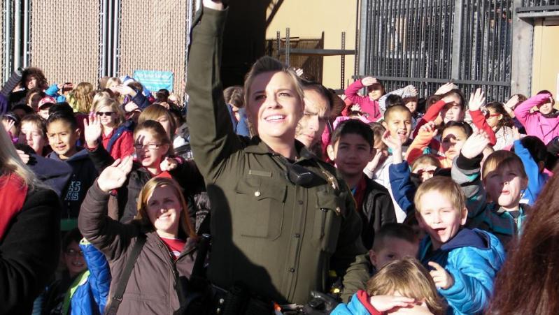 Carson City Sheriff's Office School Resource Officer Jessica Boggan awaits Santa's arrival at the 2015 Holiday with a Hero.