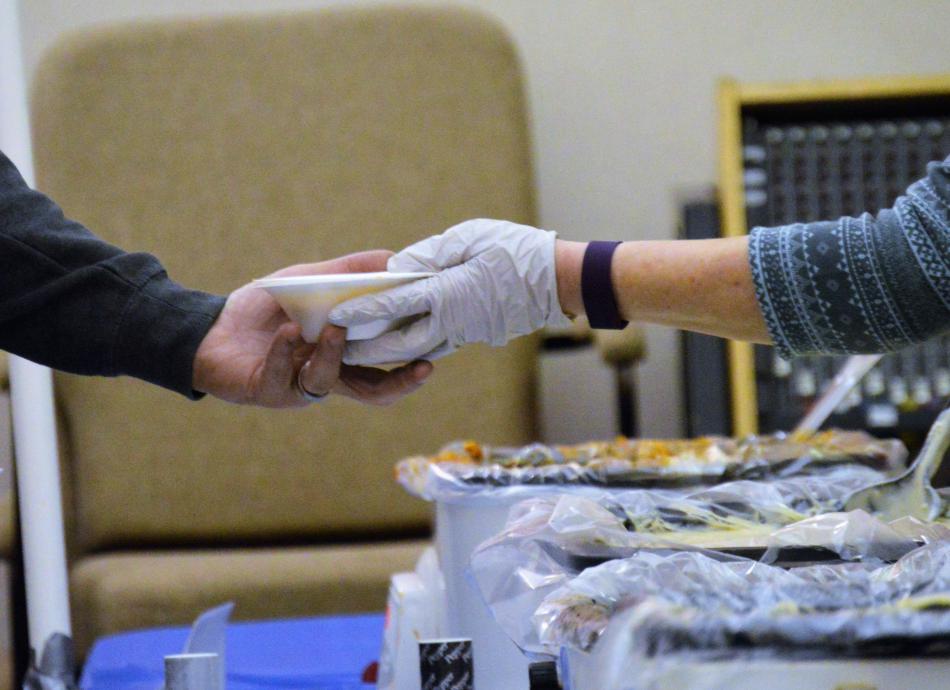 Soup is served Friday night to a guest at the Empty Bowls fundraiser.