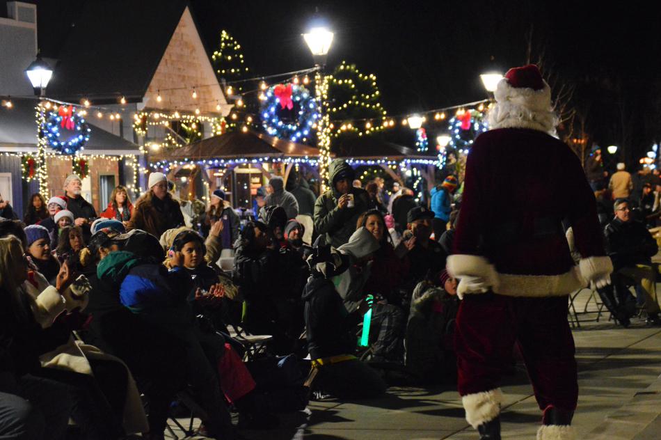 Santa entertrains the crowd sitting before the stage on McFadden Plaza.