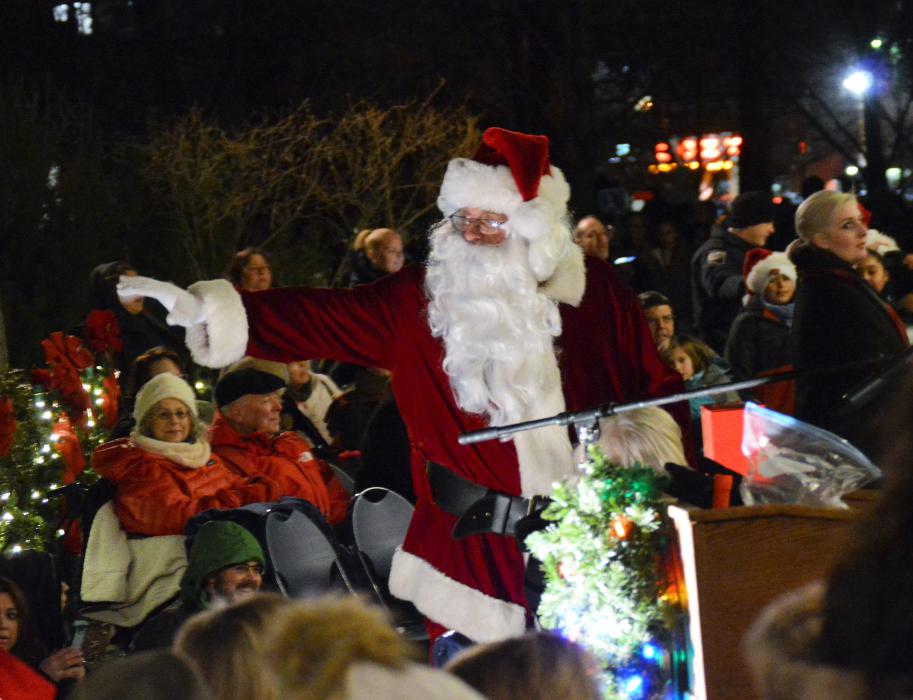 Santa Claus waves to the crowd Friday night at the Capitol.