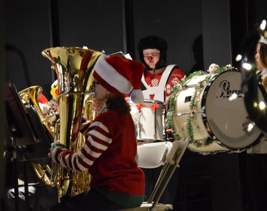 A tuba player and drums play in the middle school band Friday night on McFadden Plaza.