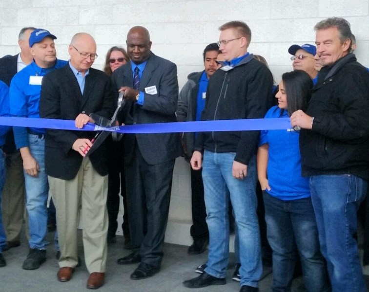 Frank Capps, left, and Store Manager Wayne Cobb cut the ribbon along with the store management team. Photos by Brett Fisher