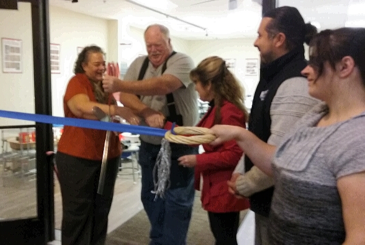 Photos by Brett Fisher. Jo and Merrill Moore cut the ribbon Saturday with Karen Abowd and Mark Salinas.