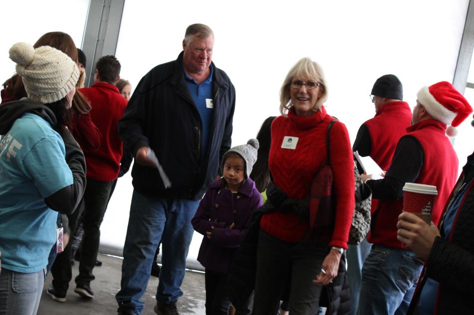 Dink Getty, owner of Genoa Trees (center), and friend Laurel Wilson, escort their Boys & Girls Club shopper into the store.