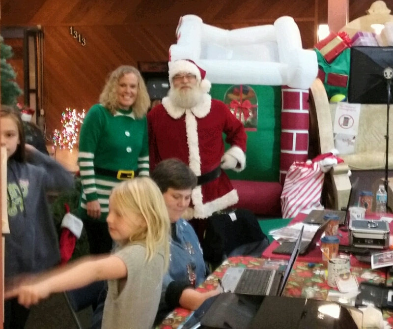 Santa Claus and an elf greet visitors to Santa's Village.