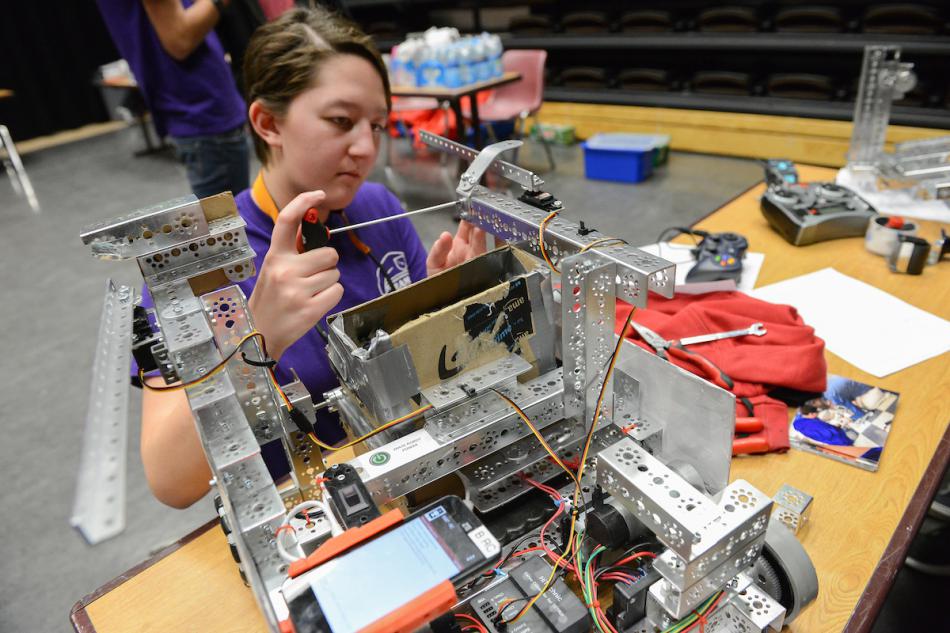 Nanami Duncan, a Carson High School student, works on a robot during the FIRST Tech Challenge event Wednesday, Dec. 14 at WNC.