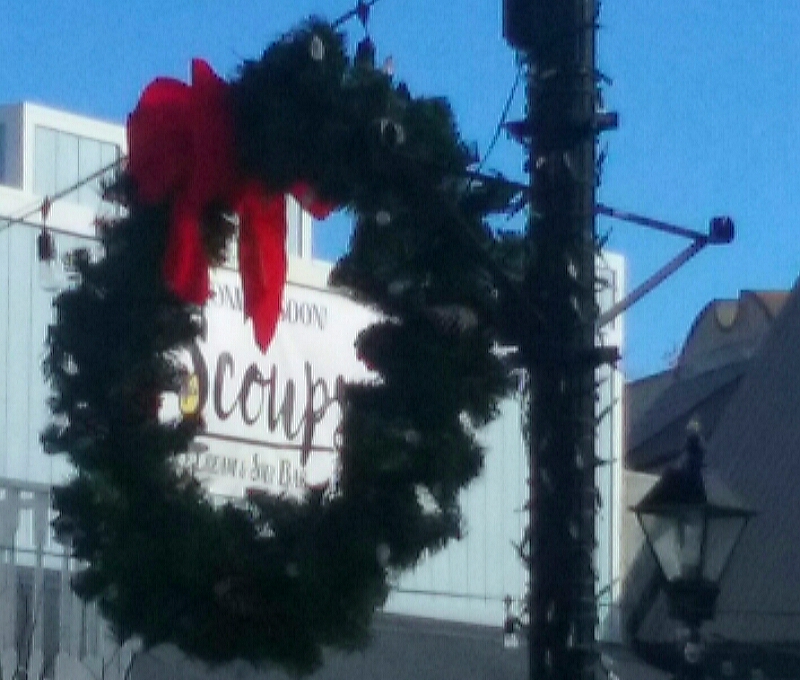The Scoups sign logo framed by a Christmas wreath.