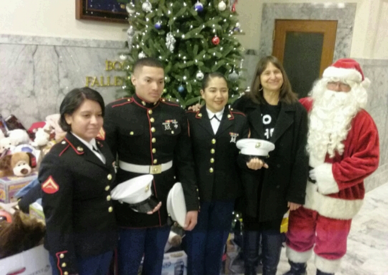 Joyce Buckingham with U.S. Marines and Santa Claus at the State Capitol.