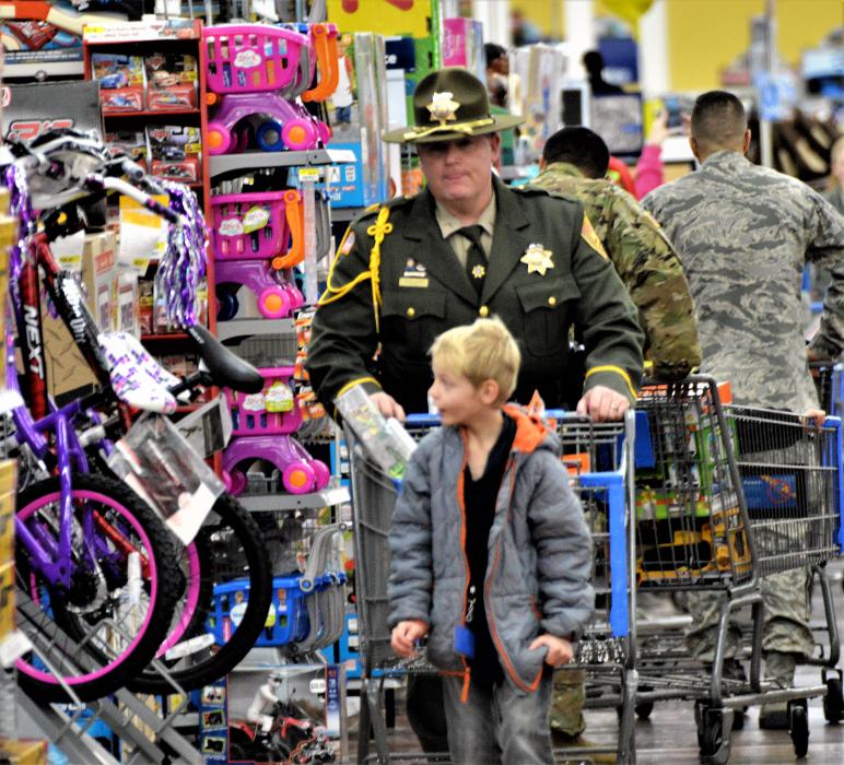 A CCSO deputy shops with a child Wednesday at Wal-Mart.