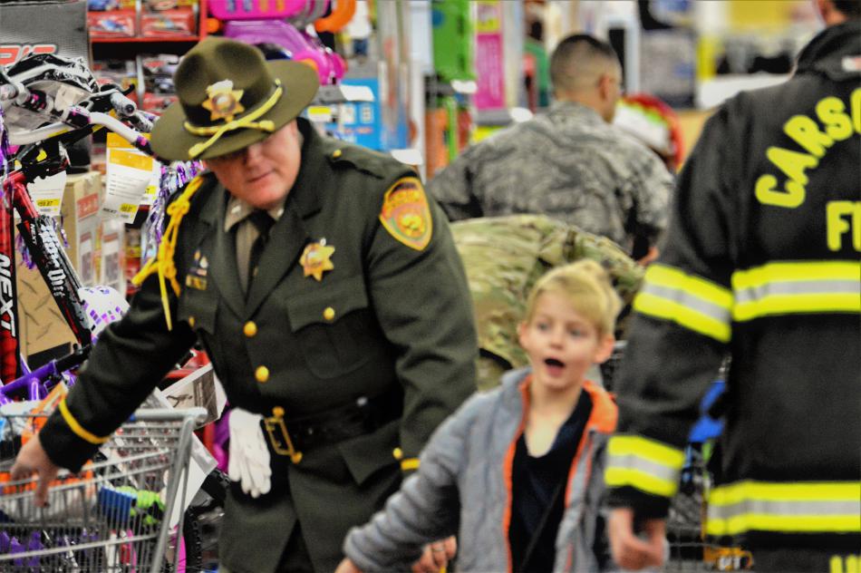 A CCSO deputy shops with a child Wednesday at Wal-Mart.