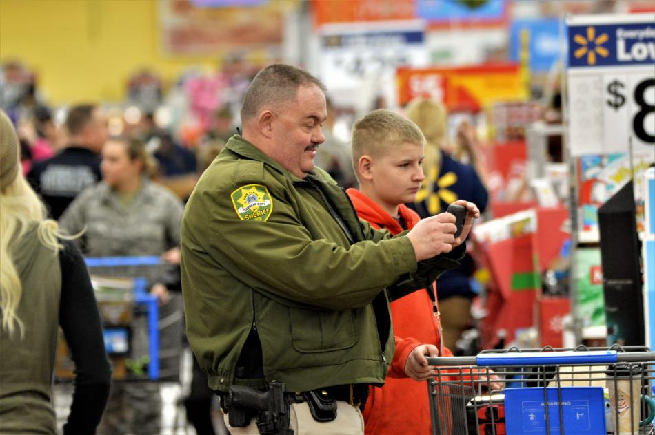 A CCSO deputy shops with a boy Wednesday at Wal-Mart.