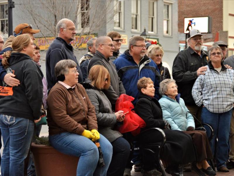 Photos by Brett Fisher. Members of the Harold Berger family gather to dedicate a bench Wednesday afternoon.
